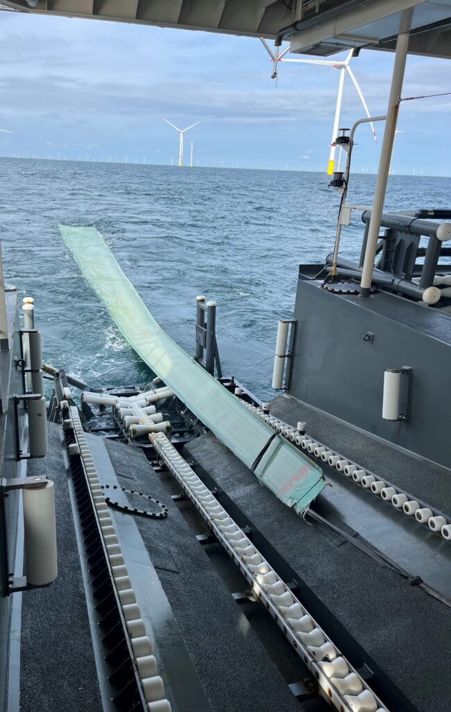 Ein Rotorblatt wird über die Heckwanne an Bord gezogen